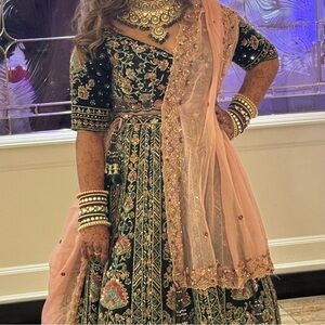 Elegant stone work and Embroidered lehenga in forest green and Pink